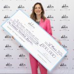 Swansea entrepreneur Jess Hickman holding a large £100000 award cheque at the Stelios Foundation awards ceremony.