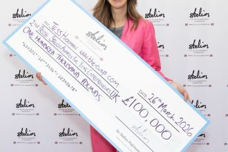 Swansea entrepreneur Jess Hickman holding a large £100000 award cheque at the Stelios Foundation awards ceremony.