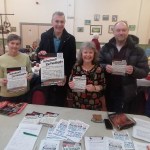 Group of campaigners holding Save Our Surgery leaflets at a community event in Pontyates.