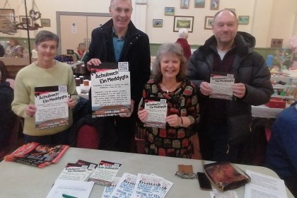 Group of campaigners holding Save Our Surgery leaflets at a community event in Pontyates.
