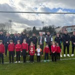 Schoolchildren and Ospreys players together on rugby pitch at St Helens Swansea during community rugby announcement