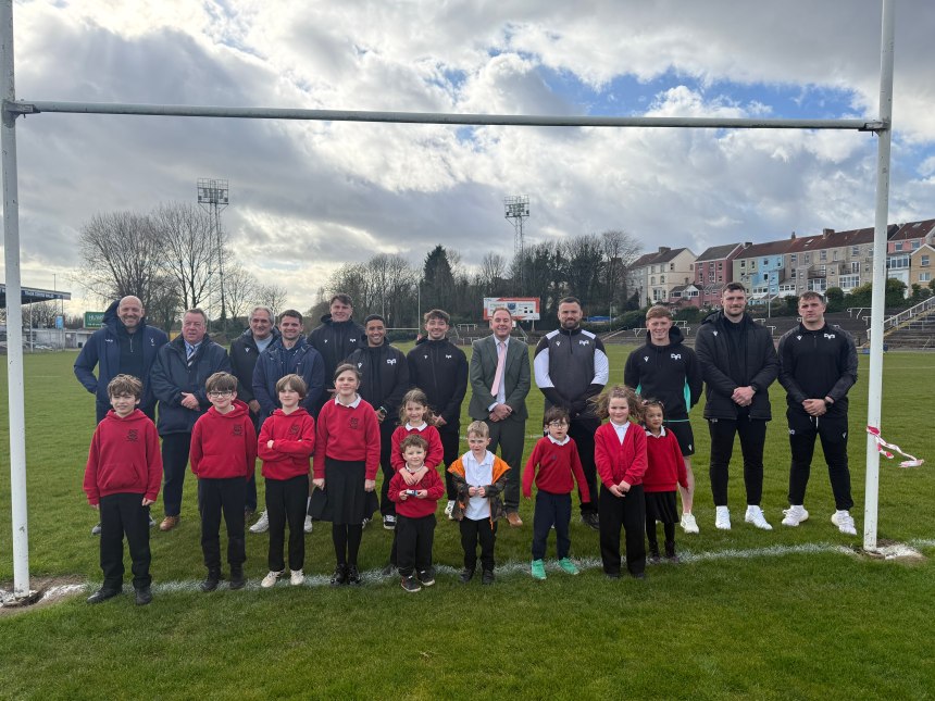 Schoolchildren and Ospreys players together on rugby pitch at St Helens Swansea during community rugby announcement