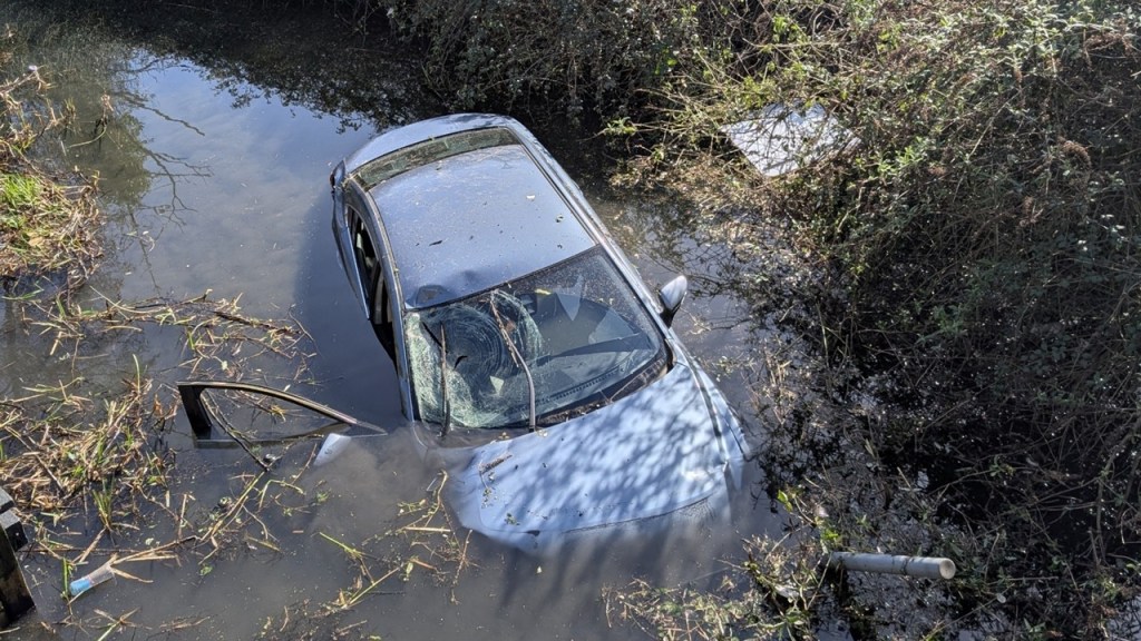 Car plunges into Neath canal as rescuers wade in to save trapped pair