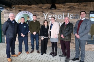 Group of councillors, school staff and project partners standing outside the new Portfield School building following completion of the first phase of redevelopment.