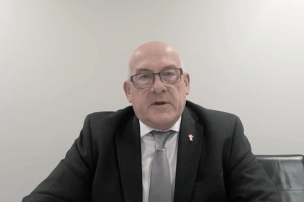 WRU Chair Richard Collier-Keywood, wearing a dark suit and grey tie with a gold WRU pin badge, speaks via video link to the Senedd committee.