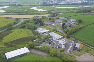 Aerial view of Coleg Sir Gar Pibwrlwyd campus in Carmarthenshire showing college buildings surrounded by countryside and river