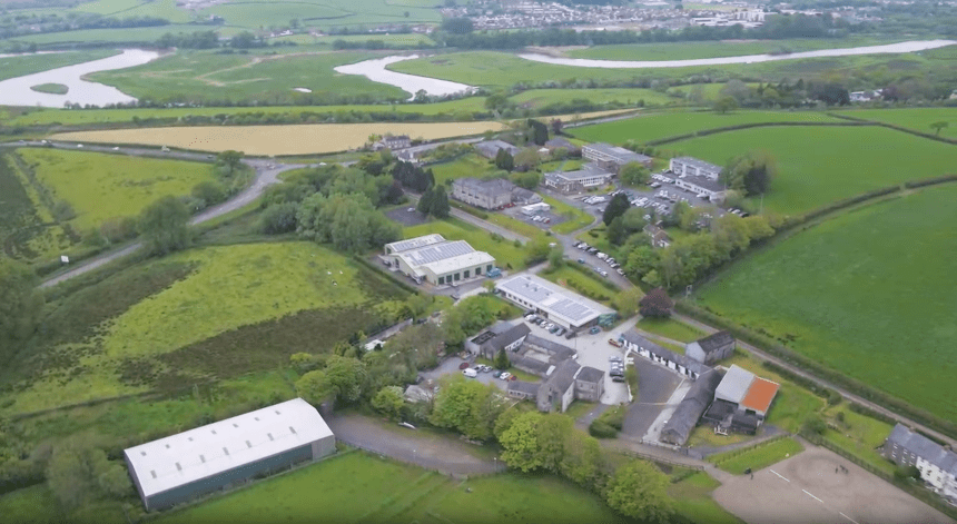 Aerial view of Coleg Sir Gar Pibwrlwyd campus in Carmarthenshire showing college buildings surrounded by countryside and river