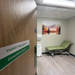Consultation room with medical bed and equipment inside refurbished Same Day Emergency Care unit at Glangwili Hospital Carmarthen