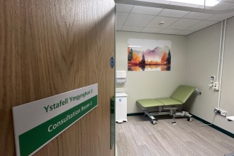 Consultation room with medical bed and equipment inside refurbished Same Day Emergency Care unit at Glangwili Hospital Carmarthen