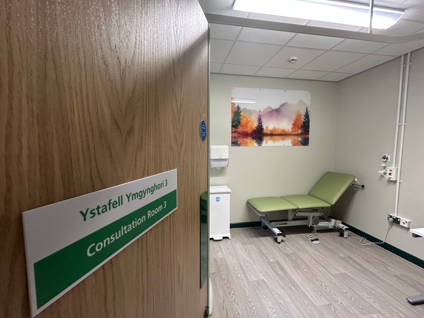 Consultation room with medical bed and equipment inside refurbished Same Day Emergency Care unit at Glangwili Hospital Carmarthen