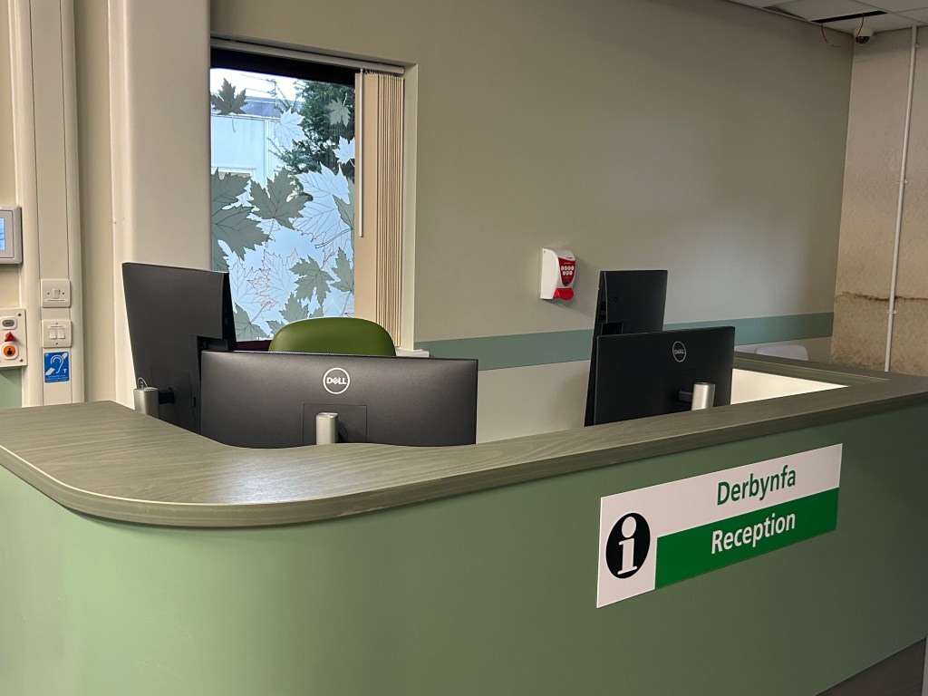 Reception desk with computers inside the refurbished Same Day Emergency Care unit at Glangwili Hospital Carmarthen