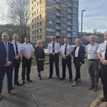 Police officers, council officials and partners standing together in Dyfatty, Swansea, during the launch of a crime reduction project