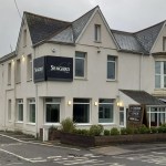 The exterior of Seagers at No 1 High Street, a restaurant building with a modern facade and prominent signage, located on a street with other commercial properties.