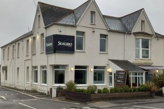 The exterior of Seagers at No 1 High Street, a restaurant building with a modern facade and prominent signage, located on a street with other commercial properties.