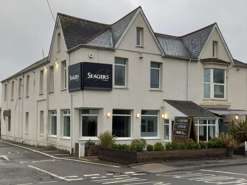 The exterior of Seagers at No 1 High Street, a restaurant building with a modern facade and prominent signage, located on a street with other commercial properties.