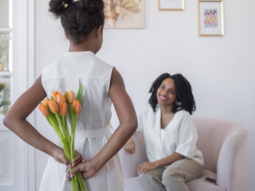 a girl surprising her mother with a bouquet of flowers