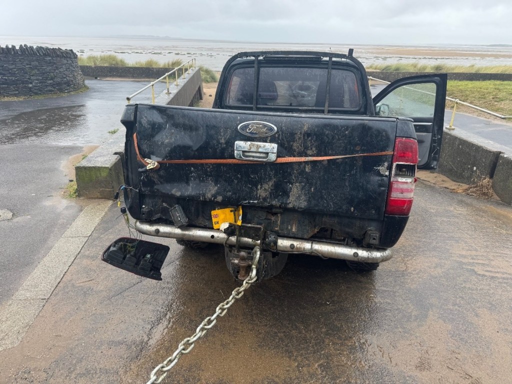4x4 vehicle being towed off the estuary