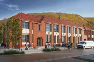 An architect's exterior render of the proposed Trefelin Pathways to Progression vocational centre in Port Talbot, showing a two-storey red brick Victorian-style building with tall windows and a matching red tiled roof, set against a green hillside
