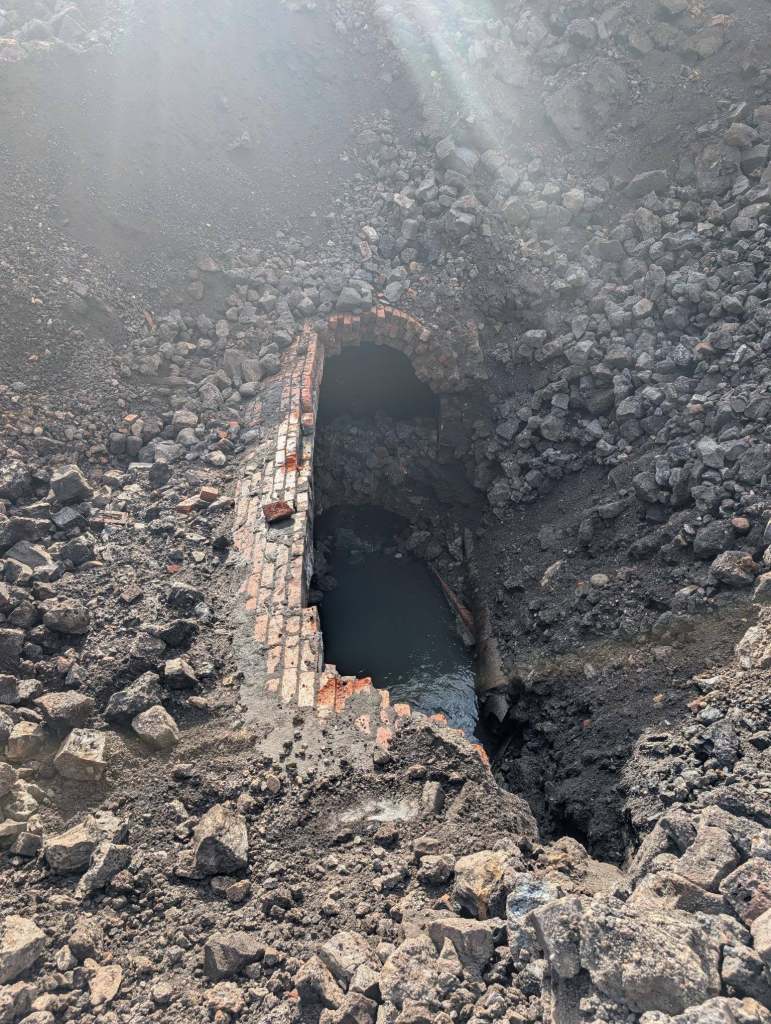 Wide view of the brick culvert running through the Cwmfelin Club excavation site in Cwmbwrla, Swansea