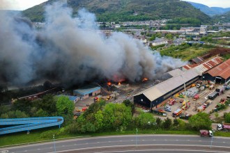 Aerial drone view of the Port Talbot Dock Road fire showing fire engines at the industrial site and thick black smoke rising over the town
