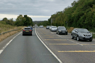 The A484 between Garden Village and Gowerton, showing the bypass route carrying traffic through a tree-lined corridor
