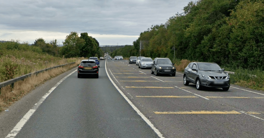 The A484 between Garden Village and Gowerton, showing the bypass route carrying traffic through a tree-lined corridor