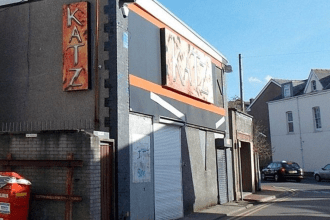 Exterior of the former Katz nightclub in Neath showing faded signage and boarded-up entrance