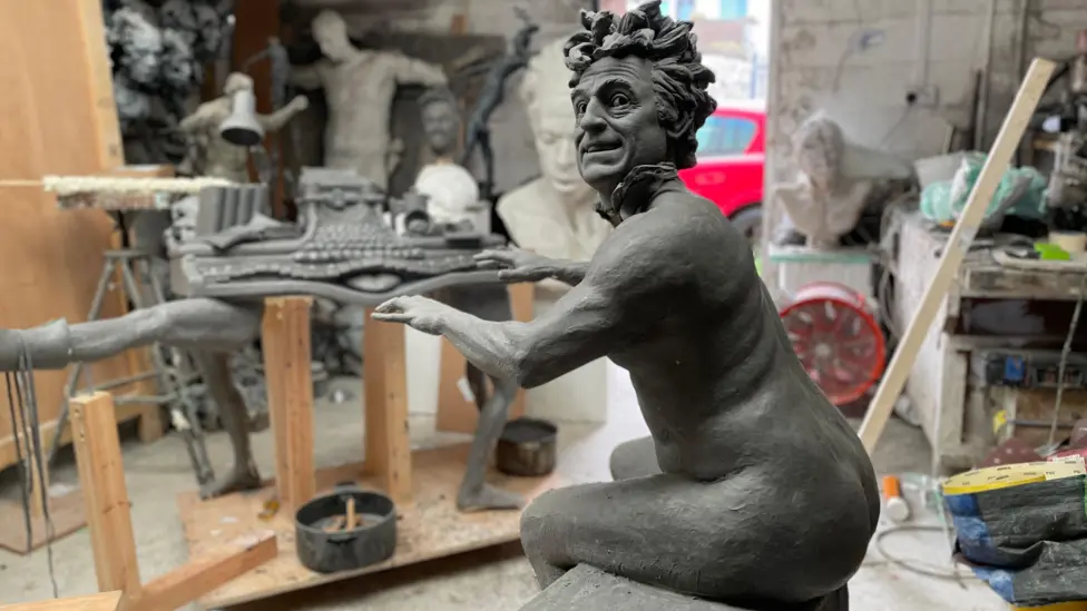 The statue, shown prior to its installation, shows Python great Terry Gilliam as the nude organist.