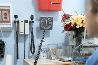 a person looking the sphygmomanometer hanging on the wall