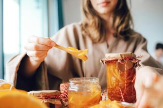 woman with spoon and jars