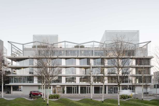 The exterior of 71/72 Kingsway in Swansea city centre, a multi-storey glass and concrete commercial building with the 71/72 logo visible on the façade, fronted by trees and a green space on The Kingsway.