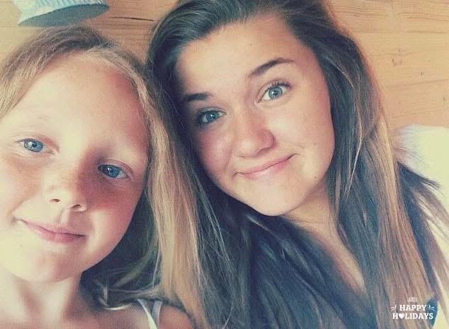 A selfie of two young girls smiling at the camera — Lexi May Hopkin on the left with blonde hair and blue eyes, and a younger Tallulah Chalstrey on the right with longer brown hair.