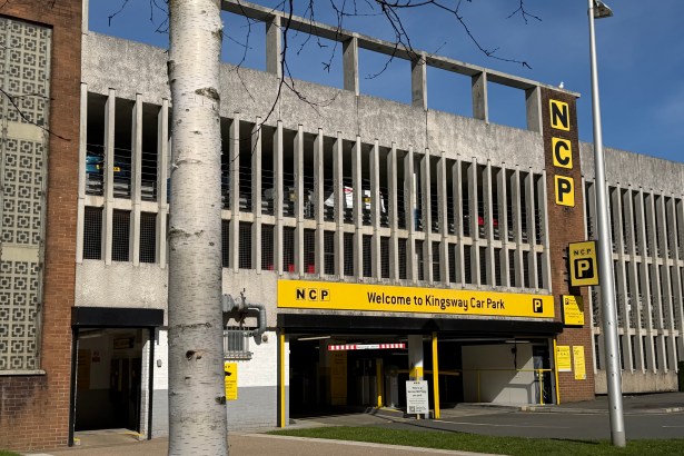 A close-up of the NCP Kingsway Car Park entrance in Swansea, showing the yellow NCP signage and Kingsway Car Park fascia with cars visible on the upper levels