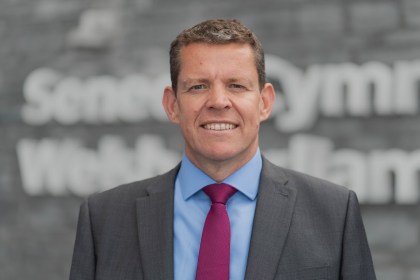 Rhun ap Iorwerth standing outside the Senedd building