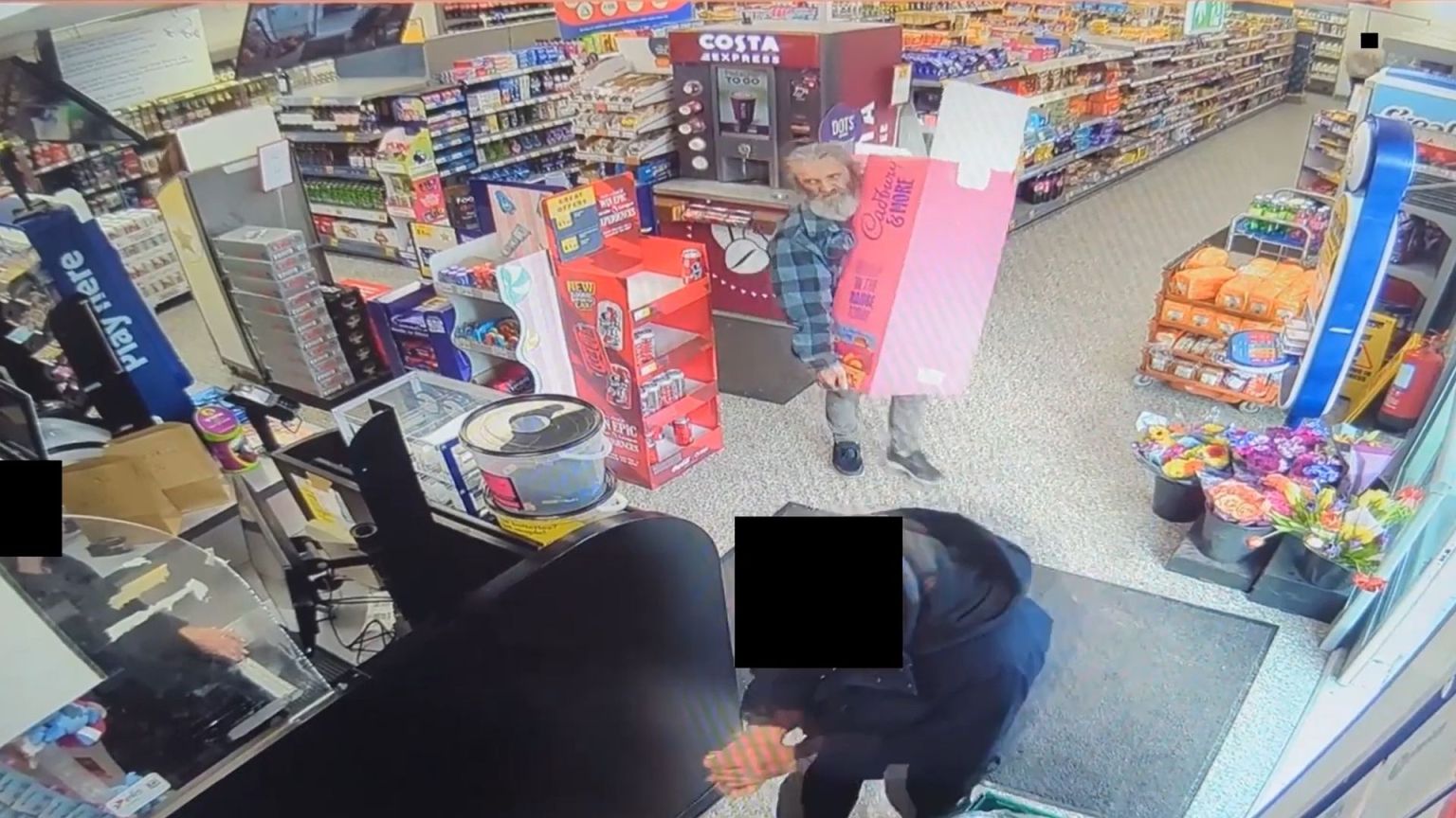 CCTV footage showing Richard Wolsey inside a convenience store carrying a large Cadbury's chocolate display stand