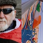 A portrait of Martin Guilfoyle, an older man with a white beard wearing a flat cap and sunglasses, alongside Irish and Palestinian flags flying from the mast of a flotilla vessel against a blue sky