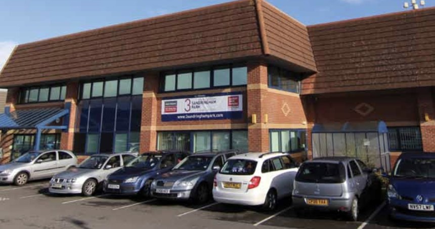 A two-storey brick office building at Sandringham Park, Swansea Vale, with cars parked outside and a "3 Sandringham Park" sign on the front.
