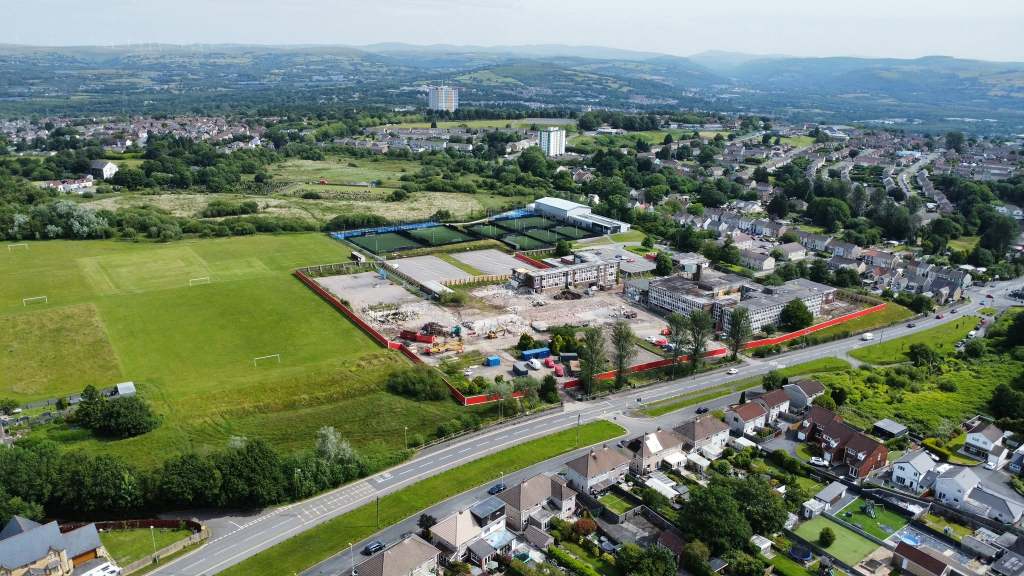 Overhead drone image showing demolition machinery and piles of rubble across the former Daniel James school site.