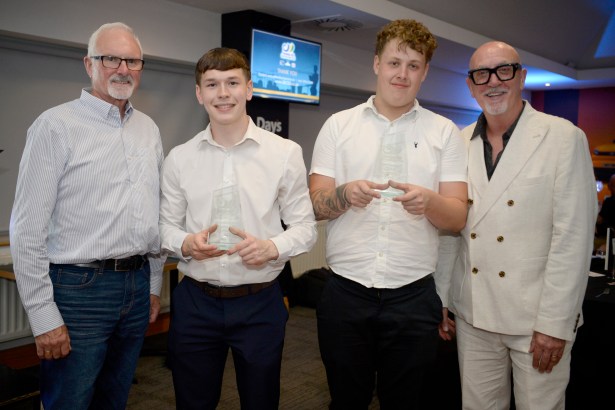 Four men stand together holding awards at the Swansea Bay Construction Support Group Awards ceremony.