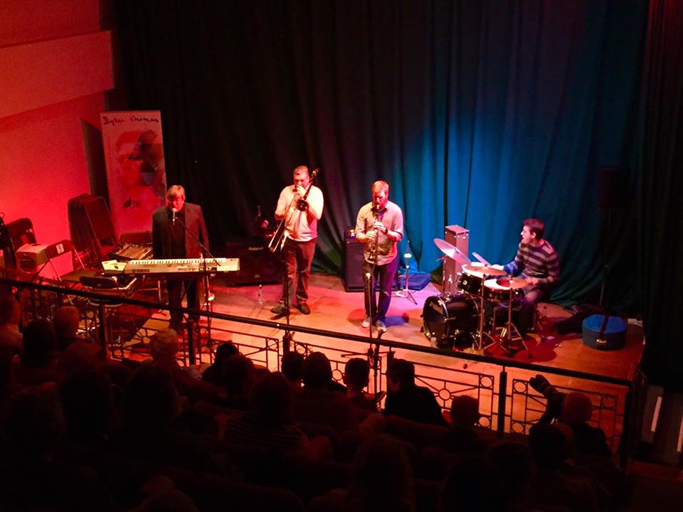Dave Cottle performing on stage with his brother and two sons at the 2026 Swansea International Jazz Festival