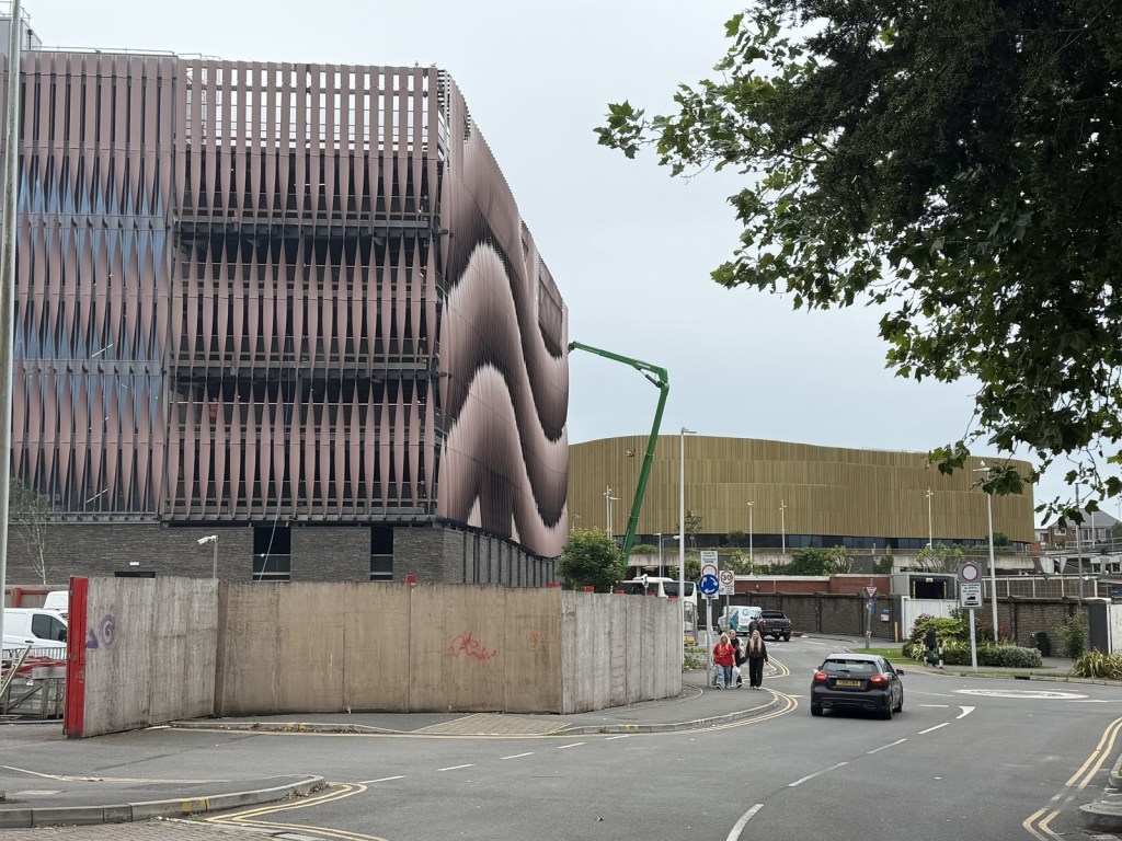 The Copr Bay North multi-storey car park with its distinctive metal fin façade, with retail units at street level.