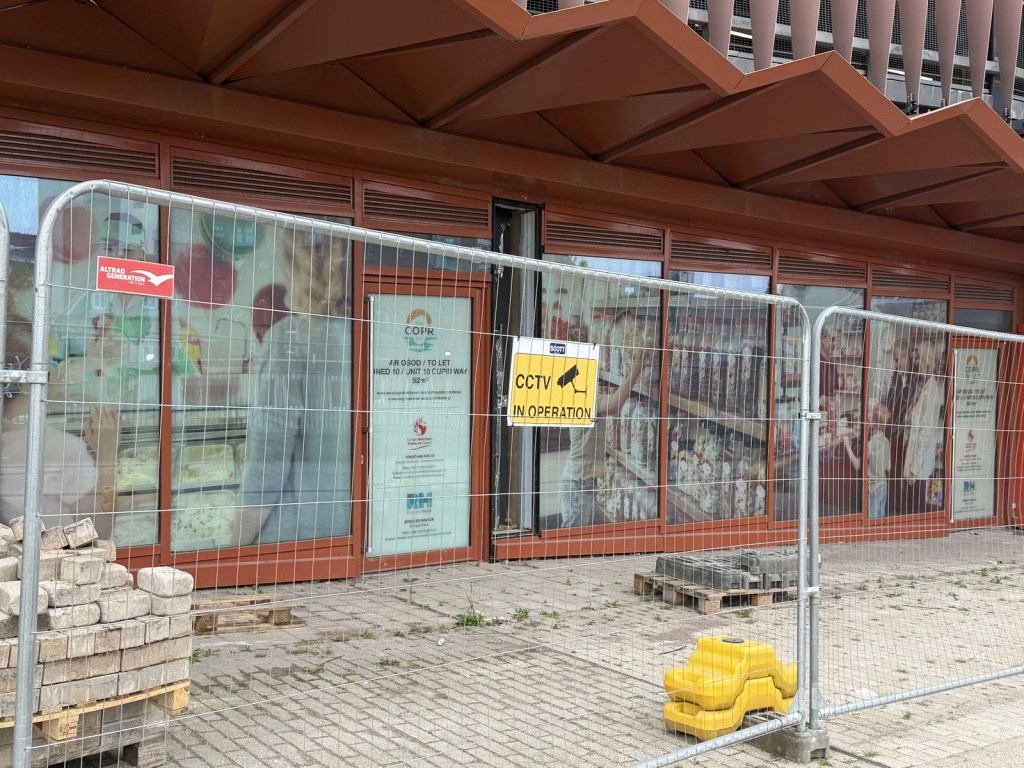 An empty retail unit on Cupid Way, its door marked "Unit 10 Cupid Way 52m²", with no tenant.