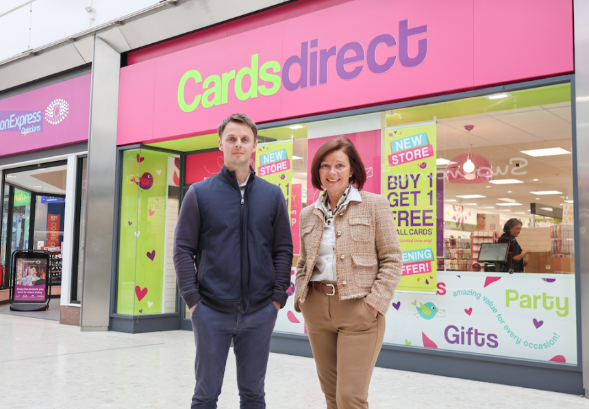 Adam Gibbons and Jane Rice standing outside the new Cards Direct store in the Quadrant Shopping Centre, with its pink shopfront and opening offer posters