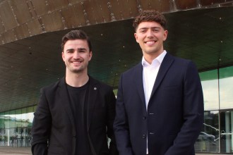 Leapfrog Advertising co-founders Fraser Dickson and Ethan Evans standing outside the Wales Millennium Centre.