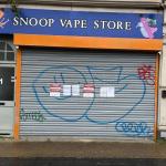 The closed orange-and-blue shutter of Snoop Vape Store on High Street, Swansea, with official Trading Standards closure notices taped to it.