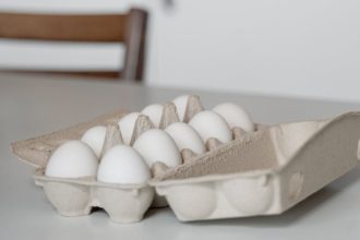 a tray of white eggs on white table