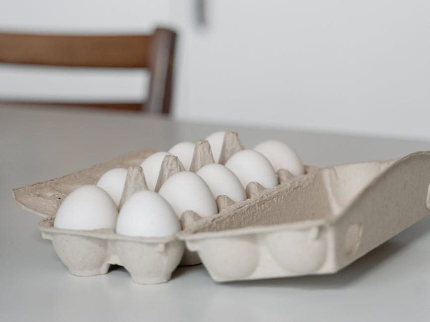 a tray of white eggs on white table