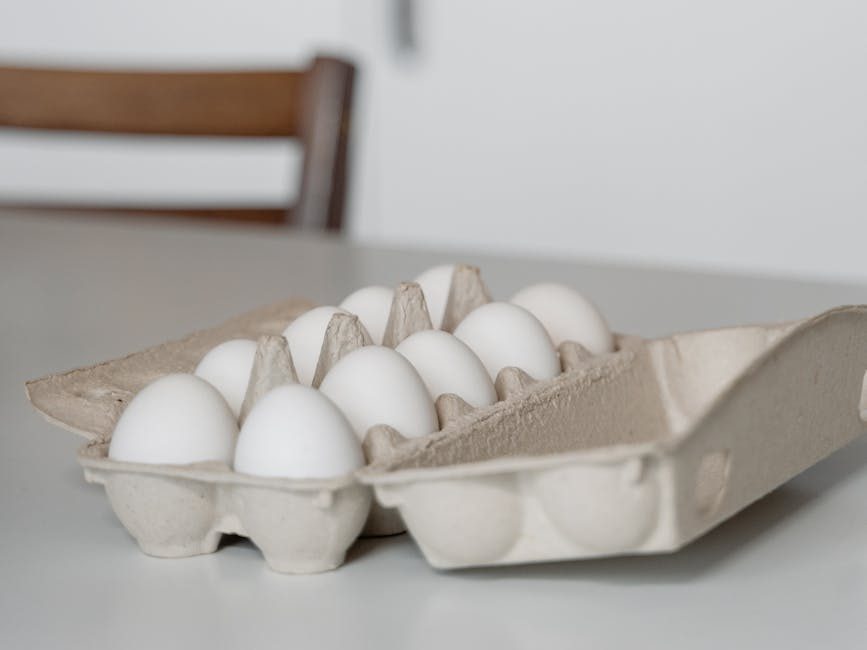 a tray of white eggs on white table