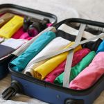 blue luggage with folded clothes