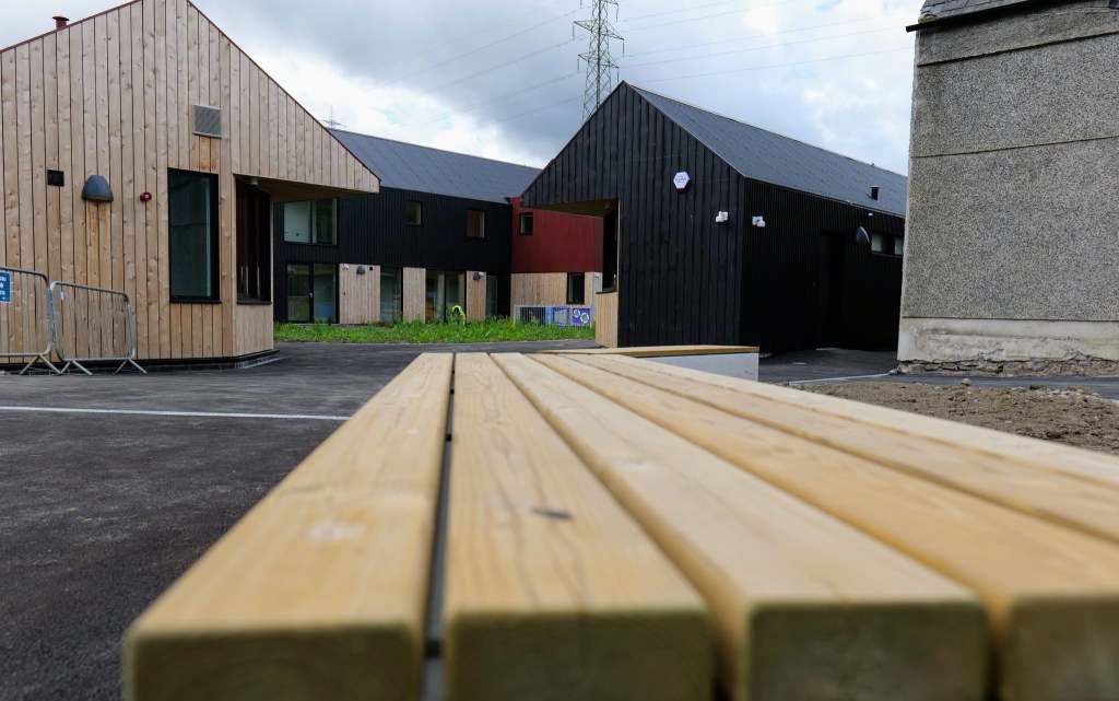 Wooden bench in the courtyard of the new visitor hub at Pontneddfechan